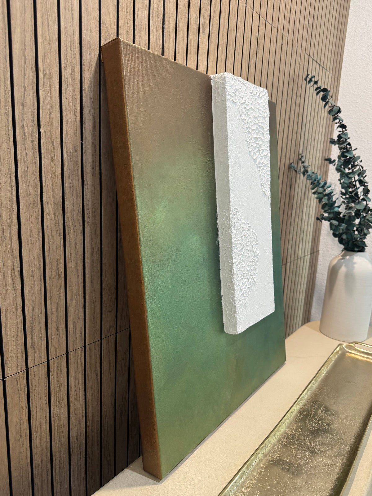 TS 02 Canopy, alternate angle — moss, olive, and earthy green field paired with a raised plaster plane | ACAYA Studio Tsitsikamma collection