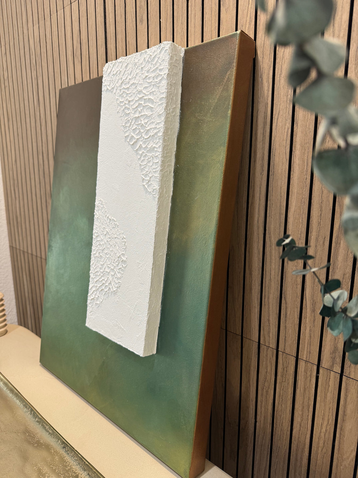TS 02 Canopy, detail view — moss, olive, and earthy green field paired with a raised plaster plane | ACAYA Studio Tsitsikamma collection