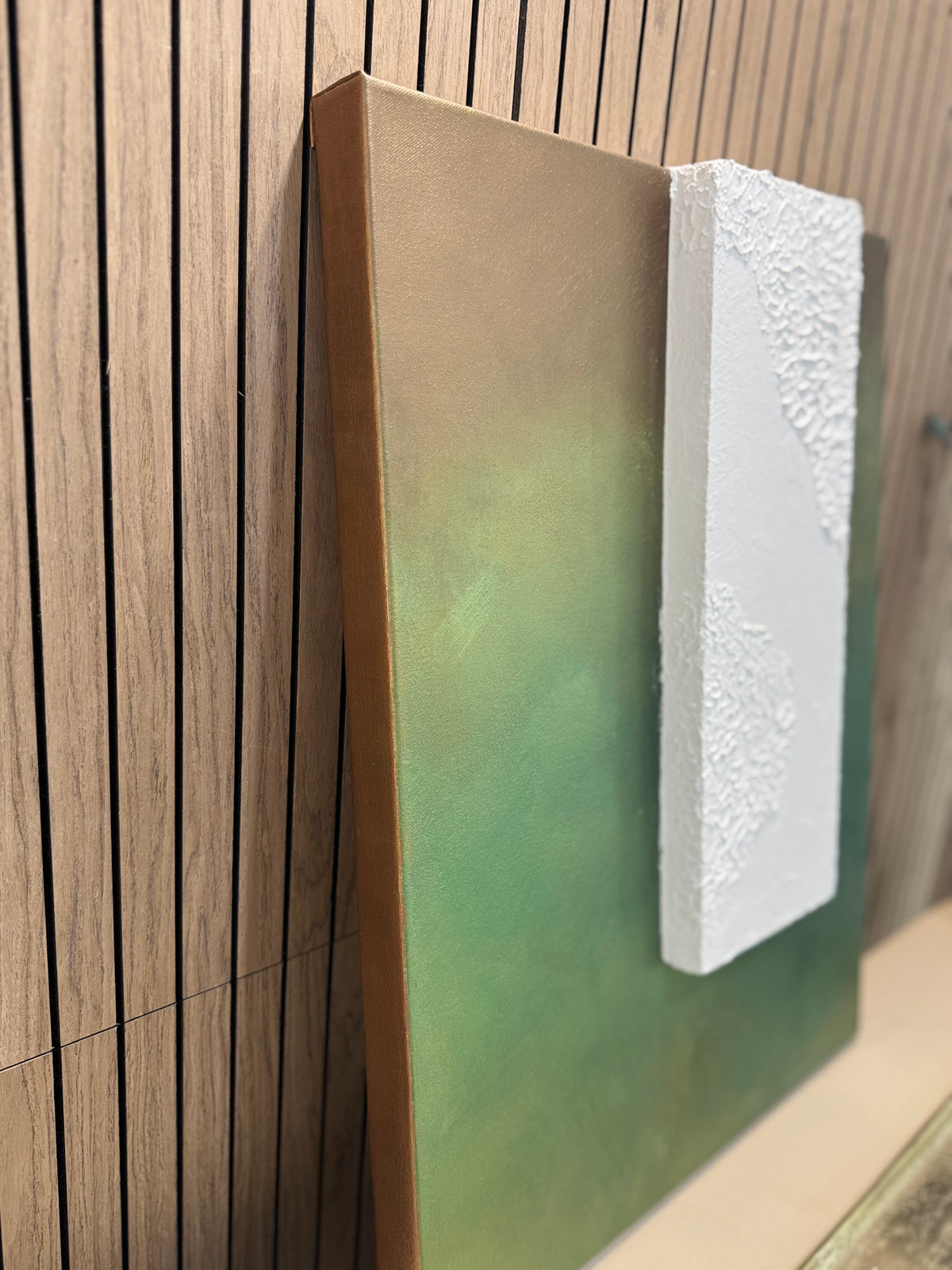TS 02 Canopy, alternate angle — moss, olive, and earthy green field paired with a raised plaster plane | ACAYA Studio Tsitsikamma collection