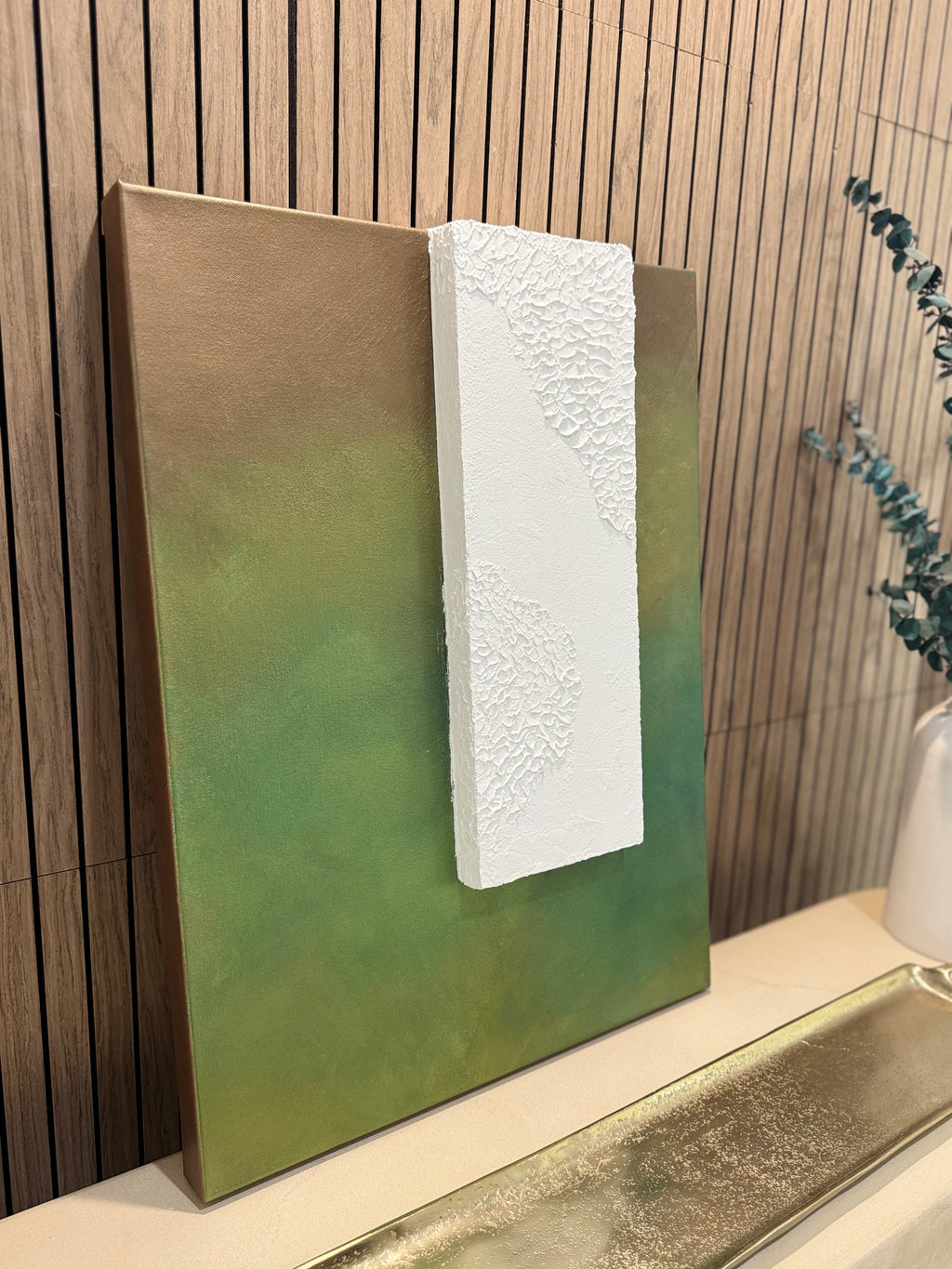TS 02 Canopy, detail view — moss, olive, and earthy green field paired with a raised plaster plane | ACAYA Studio Tsitsikamma collection