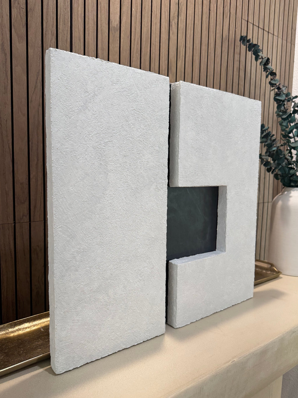 TS 03 Current, detail view — two pale stone planes separated by a recessed gunmetal passage | ACAYA Studio Tsitsikamma collection