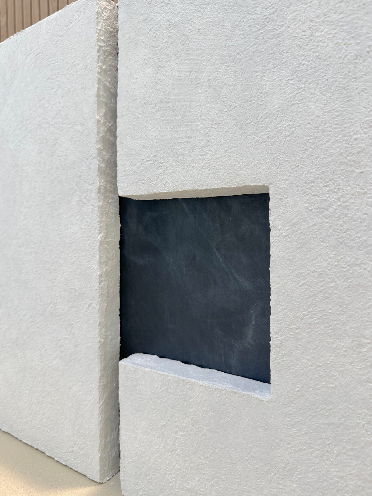 TS 03 Current, detail view — two pale stone planes separated by a recessed gunmetal passage | ACAYA Studio Tsitsikamma collection