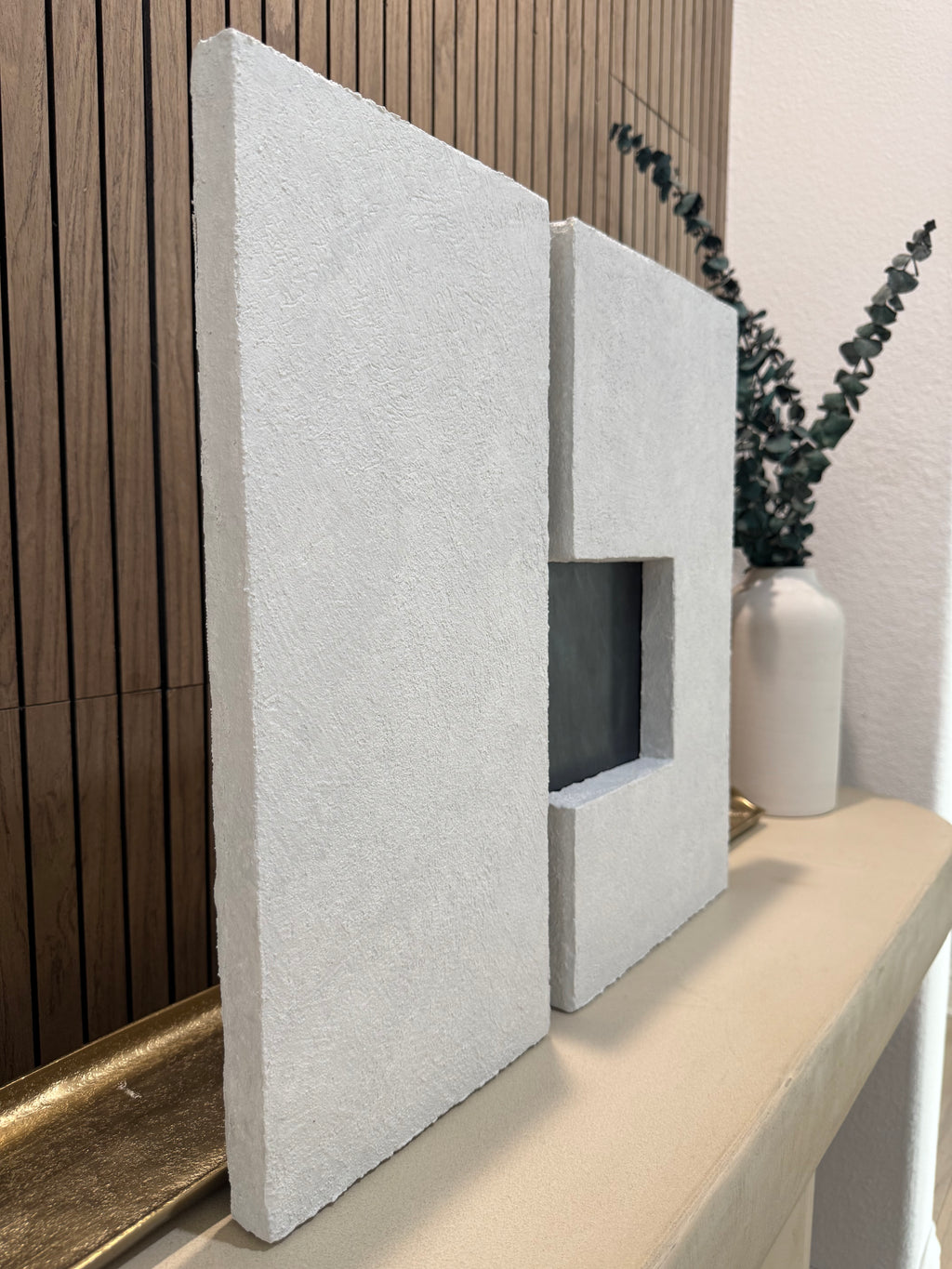TS 03 Current, alternate angle — two pale stone planes separated by a recessed gunmetal passage | ACAYA Studio Tsitsikamma collection