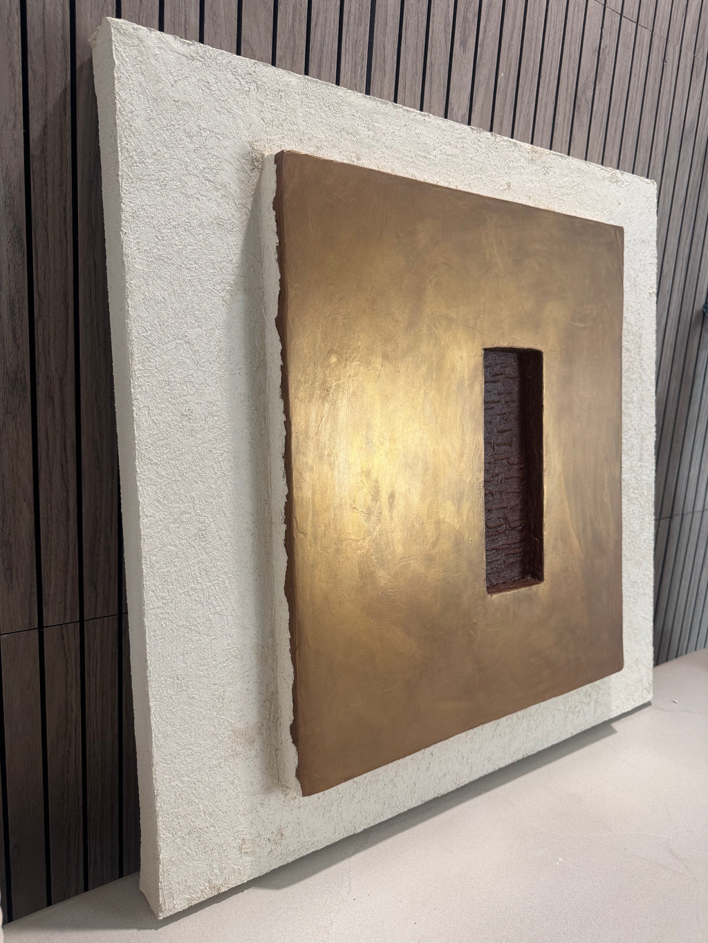 KR 04 Hearth, alternate angle — raised bronze plane with a recessed oxblood-red void | ACAYA Studio Kruger collection