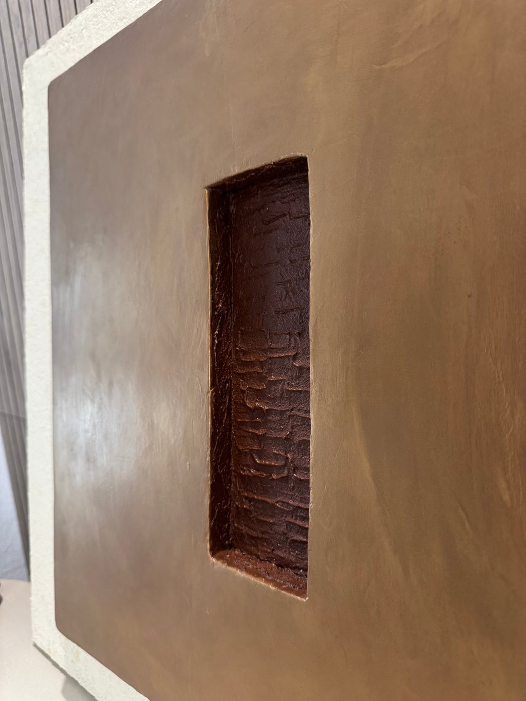 KR 04 Hearth, detail view — raised bronze plane with a recessed oxblood-red void | ACAYA Studio Kruger collection
