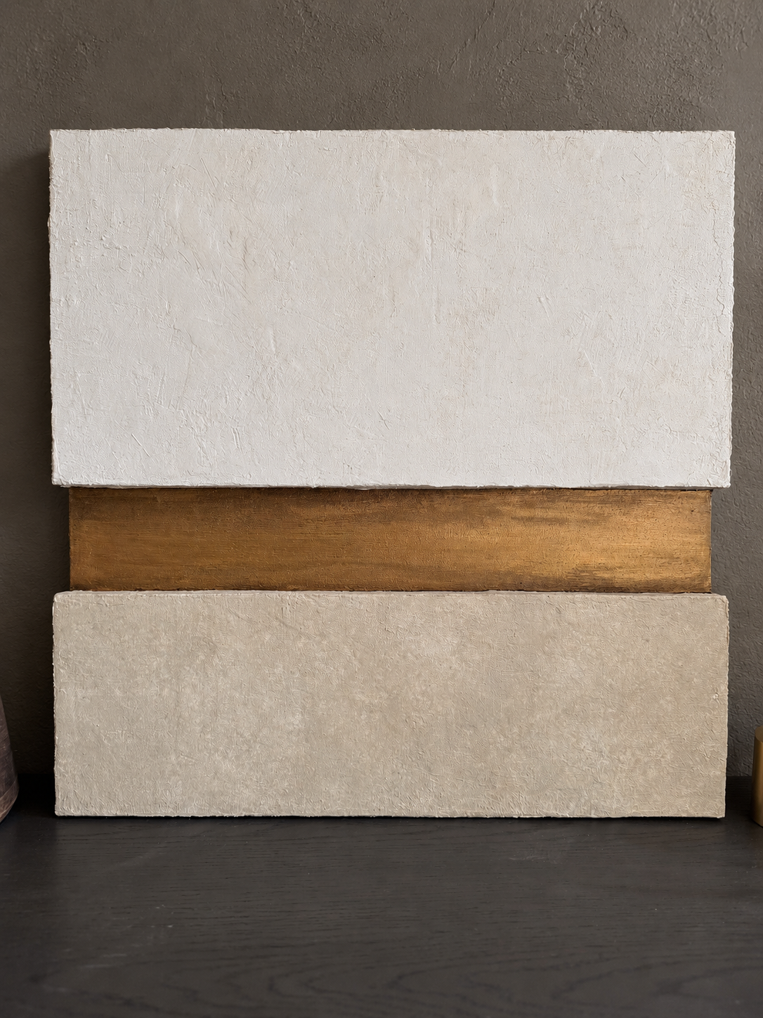 KR 03 Strata, alternate angle — pale and taupe plaster planes stacked around a recessed gold-and-bronze band | ACAYA Studio Kruger collection