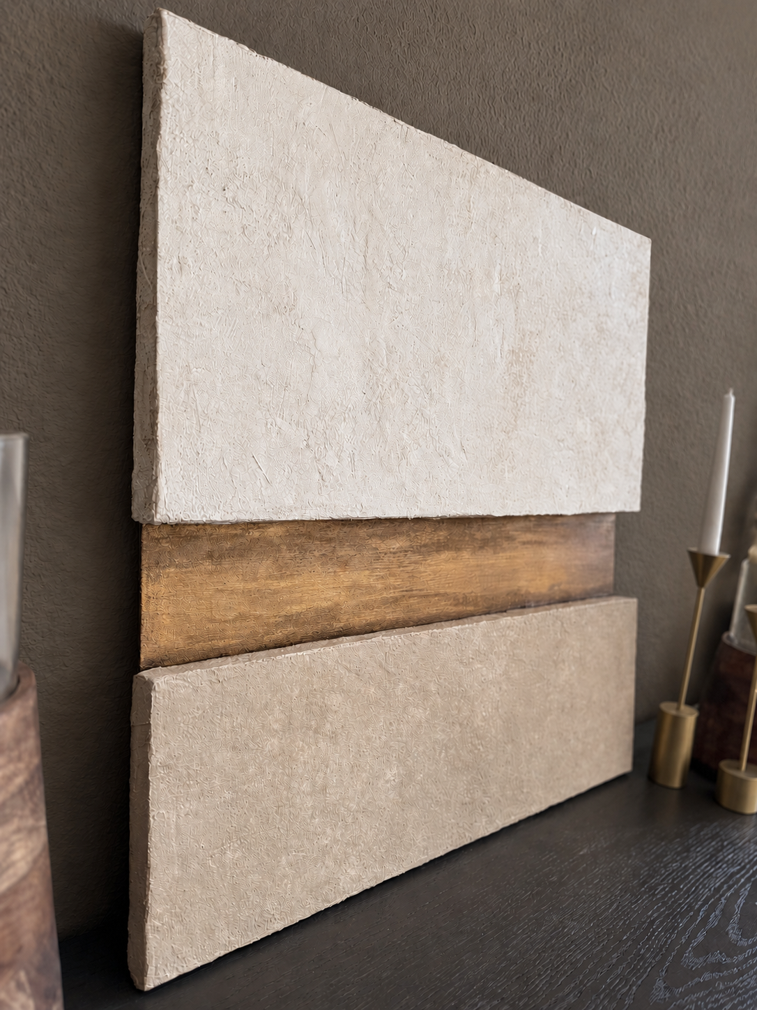 KR 03 Strata, detail view — pale and taupe plaster planes stacked around a recessed gold-and-bronze band | ACAYA Studio Kruger collection